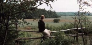 The mother (Margarita Terekhova) watches the road her husband may return on in Andrei Tarkovsky's Mirror (1975)