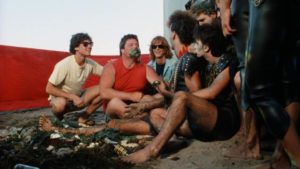 Johnny Big Head (Joshua Cadman) and head zombie Jocko (Tom Villard) to a gross eating contest in Randall Badat's Surf II (1983)