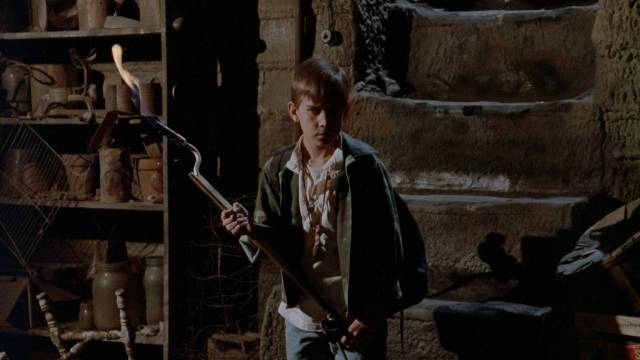 Willy (Chris Miller) confronts the monster living under the family home in Kevin S. Tenney's The Cellar (1989)