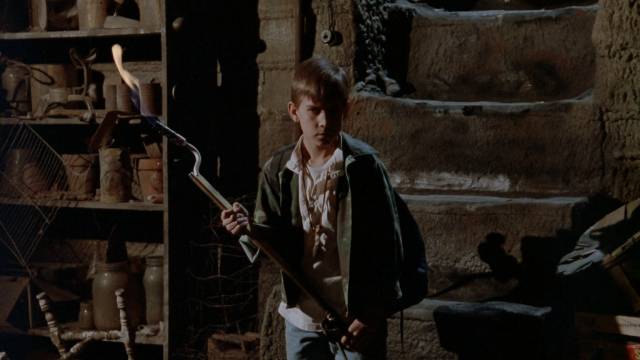 Willy (Chris Miller) confronts the monster living under the family home in Kevin S. Tenney's The Cellar (1989)