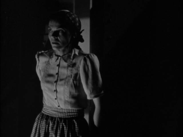 Housekeeper Mrs. Marcy (Dorothy Adams) discovers what's concealed in Dr. Blair (Boris Karloff)'s lab in Edward Dmytryk's The Devil Commands (1941)