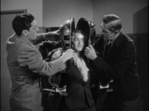 Helen Blair (Shirley Warde) cheerfully takes part in husband Dr. Julian Blair (Karloff)'s experiment in Edward Dmytryk's The Devil Commands (1941)