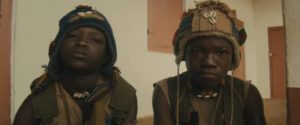 Strika (Emmanuel Nii Adom Quaye) becomes the closest thing to a friend Agu (Abraham Attah) finds in his new life in Cary Joji Fukunaga’s Beasts of No Nation (2015)