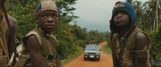 Agu (Abraham Attah) and Strika (Emmanuel Nii Adom Quaye) head towards battle in Cary Joji Fukunaga's Beasts of No Nation (2015)