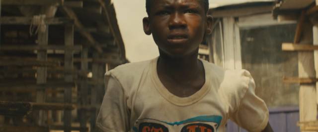 Agu (Abraham Attah) runs for his life after his family is murdered in Cary Joji Fukunaga’s Beasts of No Nation (2015)