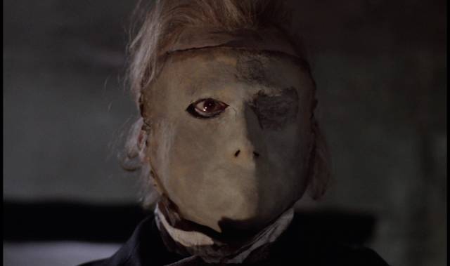 The opera ghost (Herbert Lom) hides his scars in Terence Fisher's The Phantom of the Opera (1962)