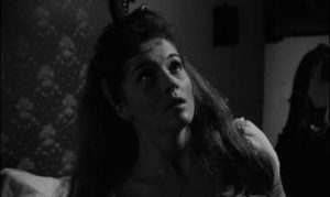 Niece Beth Venable (Barbara Shelley) hears footsteps in the attic in John Gilling's The Shadow of the Cat (1962)