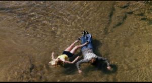 A killer's victims drift downstream in David Nelson's Death Screams (1982)