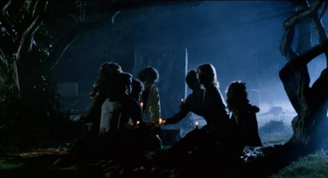 Pausing for campfire tales in a graveyard in David Nelson's Death Screams (1982)