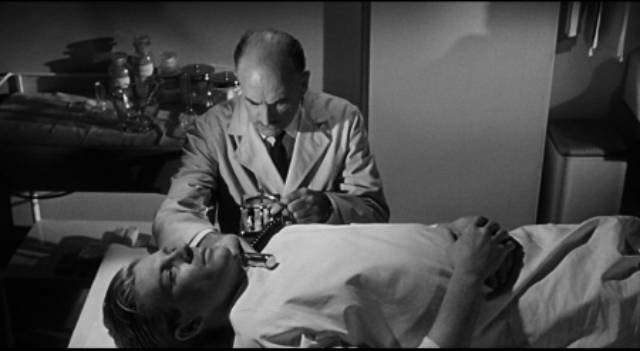 Scott Carey (Grant Williams) is examined by specialists who pinpoint the cause of his condition in Jack Arnold's The Incredible Shrinking Man (1957)