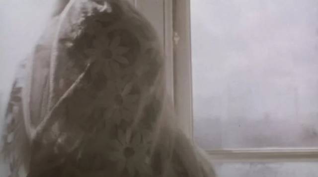 Ryan (Thomas McTaggart) wraps himself in a lace curtain like a shroud in Lynne Ramsay's Ratcatcher (1999)