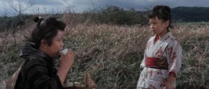Miyo (Masami Burukido) meets helpful people as well threats on the road in Along with Ghosts (1969)
