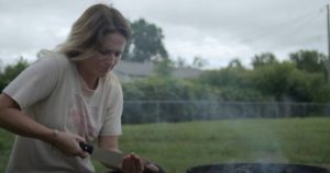 Katie (Katie Groshong) tries to ward off evil with a burned cat and fresh blood in Chad Crawford Kinkle's Dementer (2019)