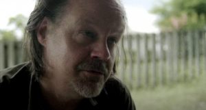 Cult leader Larry (Larry Fessenden) maintains a powerful hold on Katie (Katie Groshong) even after her escape from the cult in Chad Crawford Kinkle's Dementer (2019)