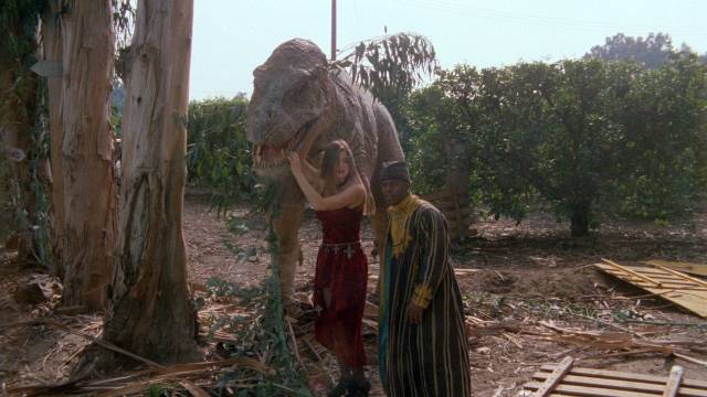 Tammy (Denise Richards) and friend Byron (Theo Forsett) hang out with the cute killer dino-bot in Stewart Raffill's Tammy and the T-Rex (1994)