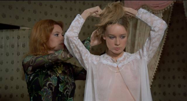 Lady Alexander (Luciana Paluzzi)'s attention to her guest hides ulterior motives in Riccardo Freda's Tragic Ceremony (1972)