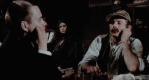 A peasant (Roman Polanski) mockingly tricks the Count's servant Anton (Arno Jürging) in a tavern in Paul Morrissey's Blood for Dracula (1974)