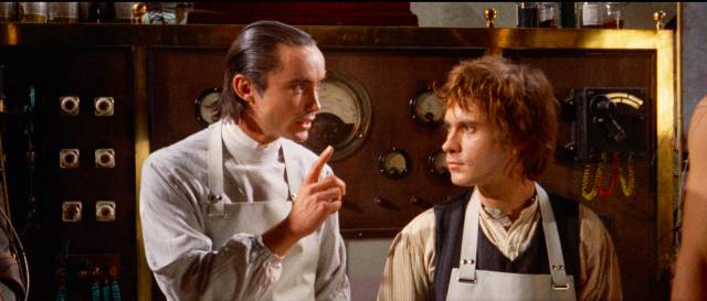 The Baron (Udo Kier) imparts knowledge to his assistant Otto (Arno Jürging) in Paul Morrissey's Flesh for Frankenstein (1973)