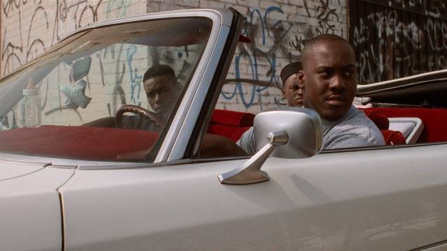 Caine (Tyrin Turner) and his friends on the look-out for trouble in the neighbourhood in the Hughes Brothers' Menace II Society (1993)