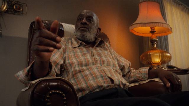 Caine (Tyrin Turner)'s grandfather (Arnold Johnson) offers religious platitudes in the Hughes Brothers' Menace II Society (1993)