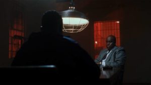 A detective (Bill Duke) questions Caine (Tyrin Turner) about the convenience store killings in the Hughes Brothers' Menace II Society (1993)