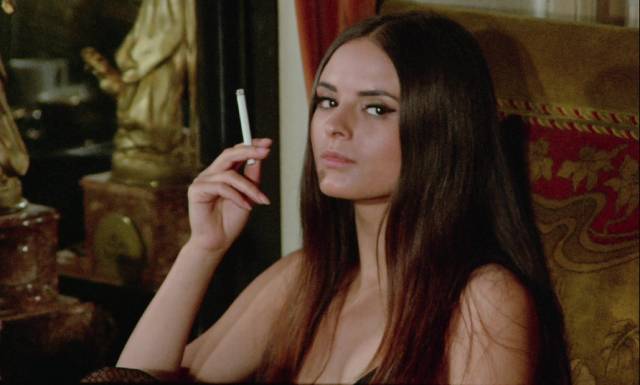 Mrs. Johnson (Soledad Miranda) stalks and kills the people she blames for her husband's death in Jess Franco's She Killed in Ecstasy (1970)