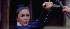 Miss LIu (Polly Ling-Feng Shang-Kuan) opposes corrupt court officials in Joseph Kuo's The Shaolin Kids (1977)