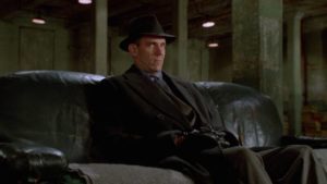 Johnny Caspar (Jon Polito)'s right-hand man the Dane (J.E. Freeman) dislikes Tom Reagan (Gabriel Byrne) in the Coen Brothers' Miller's Crossing (1990)