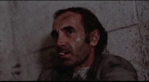 Visconti (Charles Aznavour) faces imprisonment with quiet fatalism in Clive Rees' The Blockhouse (1973)