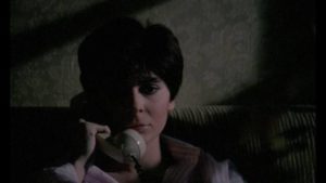 Student Christiana Marelli (Mariangela D'Abbraccio) gets threatening phone calls in Camillo Teti’s The Killer is Still Among Us (1986)