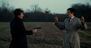 Vogel (Gian Maria Volontè)'s distrust is allayed with a cigarette in Jean-Pierre Melville's Le cercle rouge (1970)