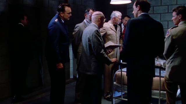 MJilitary authorities and scientists look at the results of their experiment in Tobe Hooper's Spontaneous Combustion (1990)