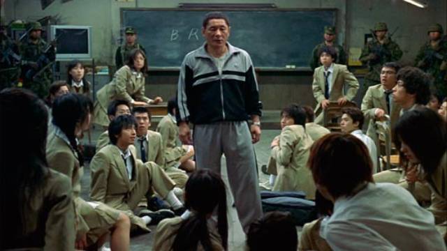 Teacher Kitano (Takeshi Kitano) explains to the class why they have to kill each other in Kinji Fukasaku's Battle Royale (2000)