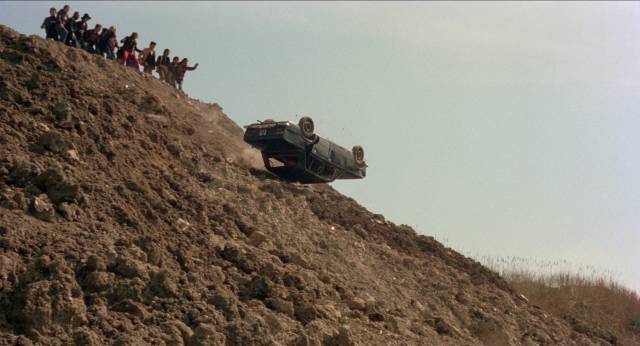 The violent gang push Inspector Palmieri (Fabio Testi)'s car off a cliff in Enzo G. Castellari's The Big Racket (1976)