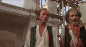 Journalist Byron Cole (Xander Berkeley) becomes disillusioned as William Walker (Ed Harris) descends into madness in Alex Cox's Walker (1987)