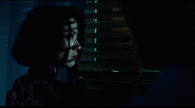 Fleur (Anita Mui) stares out at a world she no longer recognizes, searching for what she has lost in Stanley Kwan's Rouge (1987)