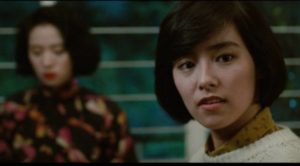 Yuen-Ting (Alex Man)'s girlfriend reporter Ah Chor (Emily Chu) becomes fascinated with Fleur (Anita Mui)'s story in Stanley Kwan's Rouge (1987)