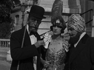 Dr. Gilson Gaston Michel), La marquise Dolorès (Georgette Faraboni) and Kistna Louis Leubas) plot to obtain the valuable cipher in Louis Feuillade's Tih-Minh (1919)