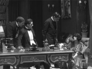 Jacques (René Cresté) and his friends capture the marquise (Georgette Faraboni) and learn the origins of the cipher in Louis Feuillade's Tih-Minh (1919)