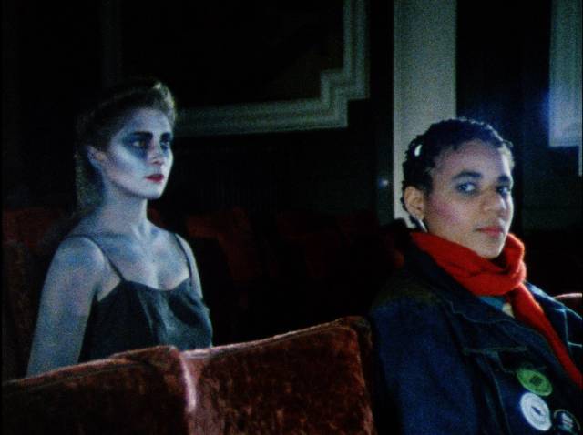 Zena (Pamela Lofton) meets vampire Lillia (Susan Franklyn) at a horror movie in The Mark of Lilith (1986)