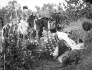 Odarka (Maria Sokil) tries to wake her husband Ivan (Michael Shvetz) in Edgar G. Ulmer's Cossacks in Exile (1938)