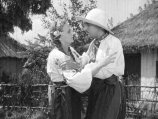 Andrey (Alexis Tcherkasshy) and Oksana (Helen Orlenko) have to separate in Edgar G. Ulmer's Cossacks in Exile (1938)