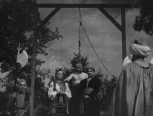 Andrey (Alexis Tcherkasshy) is condemned to death in Edgar G. Ulmer's Cossacks in Exile (1938)