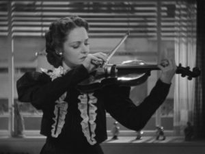 Kártély Gyöngyi (Maria Tasnadi Fekete) makes a precarious living as a musician in André De Toth's Two Girls on the Street (1939)
