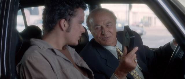 Mr Eddy (Robert Loggia) offers Pete (Balthazar Getty) a porno tape in David Lynch's Lost Highway (1996)