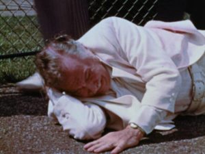 Horrified by the prospect of getting old, the young man attacks the elderly man in George A. Romero's The Amusement Park (1975)