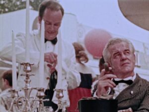 A wealthy man gets obsequious restaurant service as the hungry poor look on in George A. Romero's The Amusement Park (1975)