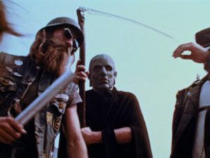 Bikers beat and rob the elderly man under the watchful gaze of Death in George A. Romero's The Amusement Park (1975)