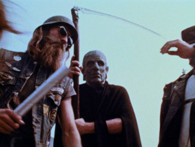 Bikers beat and rob the elderly man under the watchful gaze of Death in George A. Romero's The Amusement Park (1975)