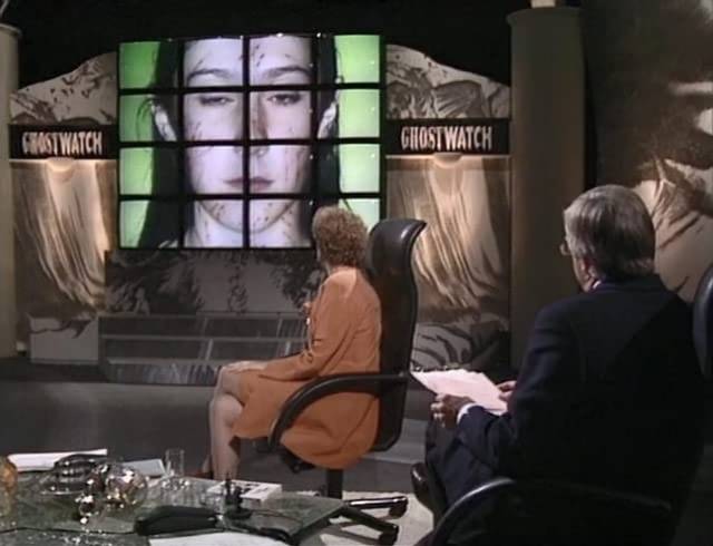 Presenter Michael Parkinson and Dr.Lin Pascoe (Gillian Bevan) check the video wall for evidence of the poltergeist in Leslie Manning's Ghostwatch (1992)